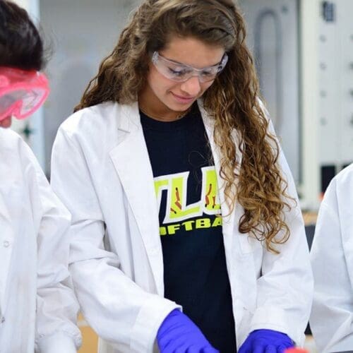 3 students in lab coats