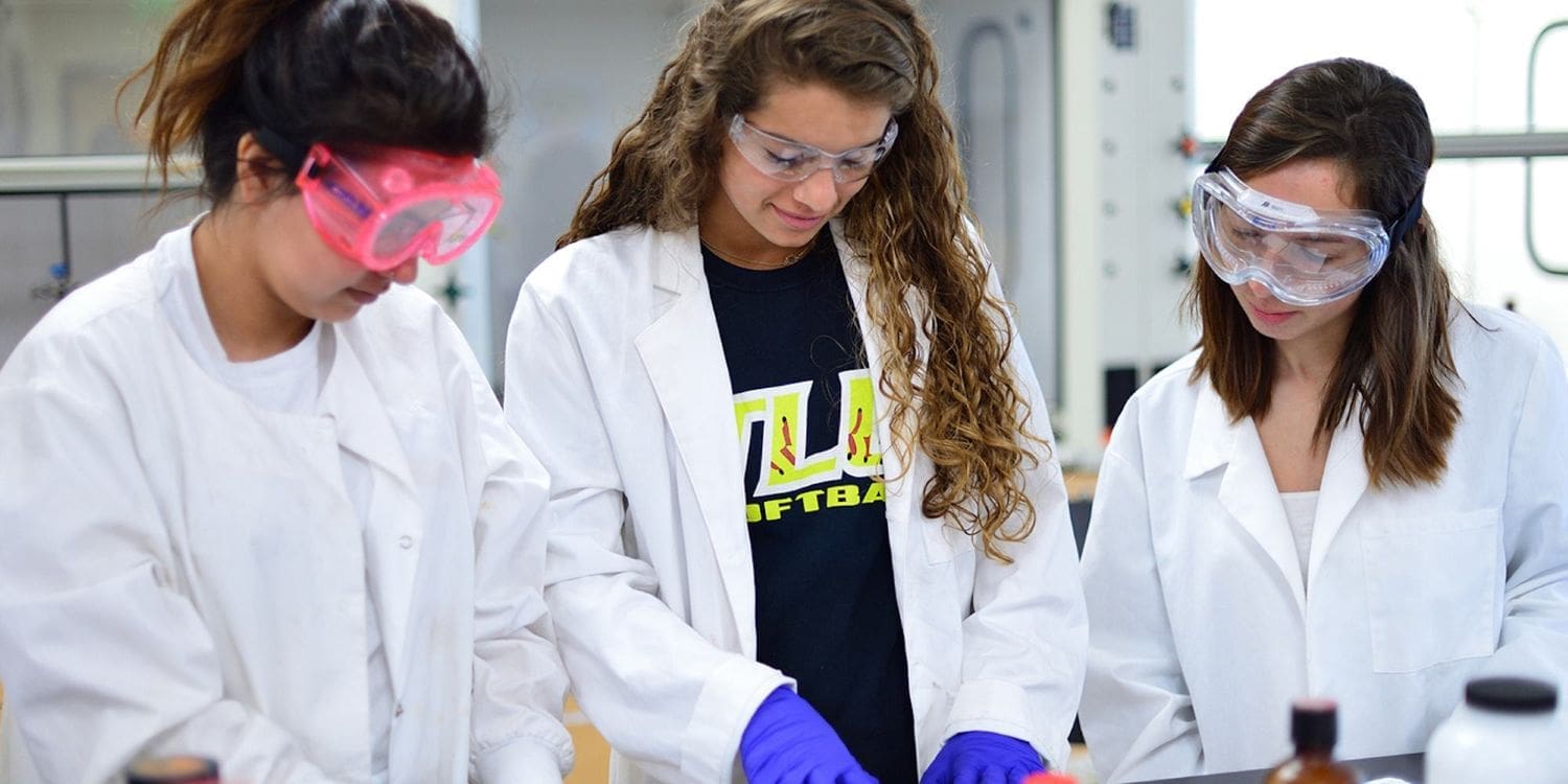 3 students in lab coats