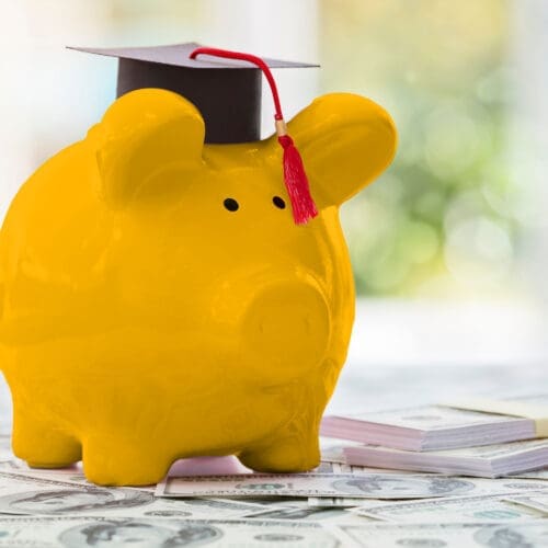Gold piggy bank in a motar board