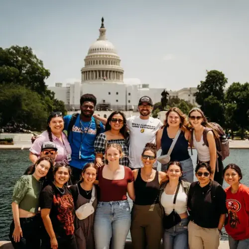 Group of students in front of capital smiling