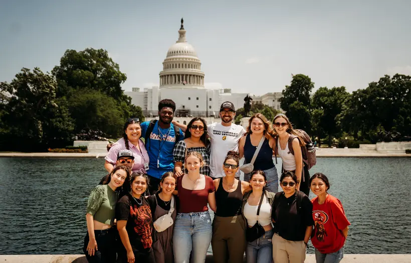 Group of students in front of capital smiling