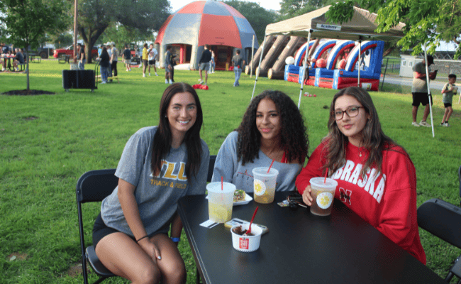 three female students at a student event on campus