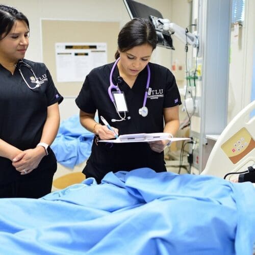two nursing students in lab