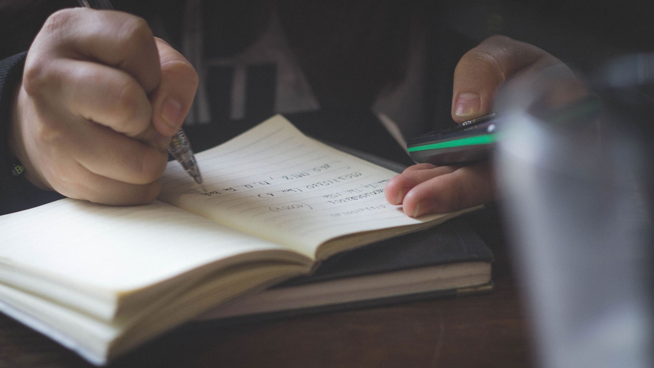 Student hand writing in a notebook