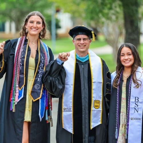 Three graduates in regalia
