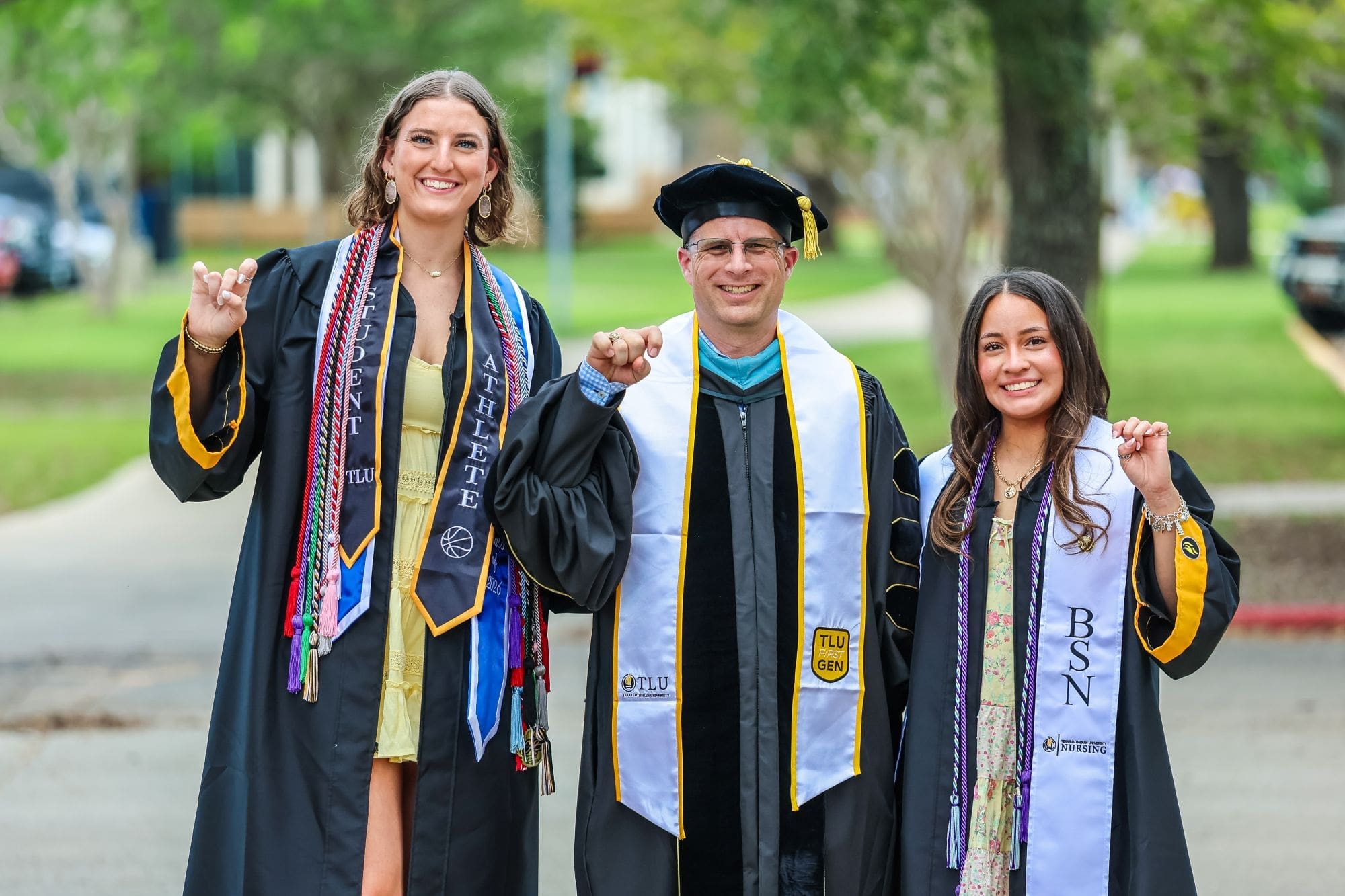 Three graduates in regalia