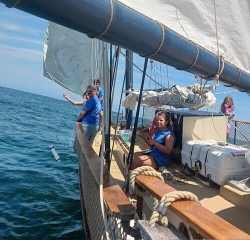 Alison Bray with students on sailboat