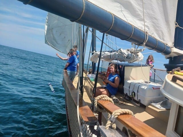 Alison Bray with students on sailboat