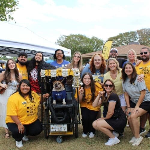 Alumni and staff with Talulah