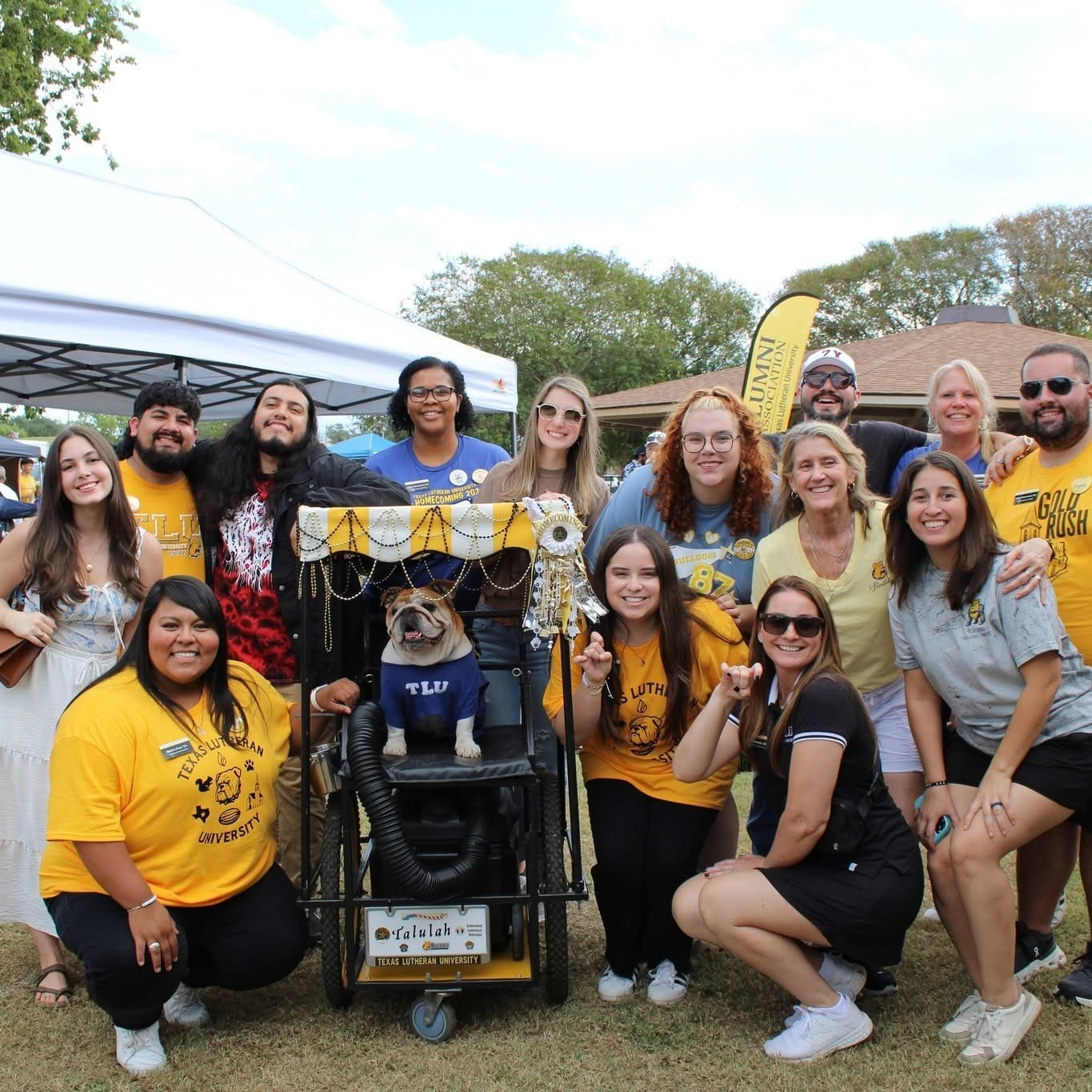 Alumni and staff with Talulah