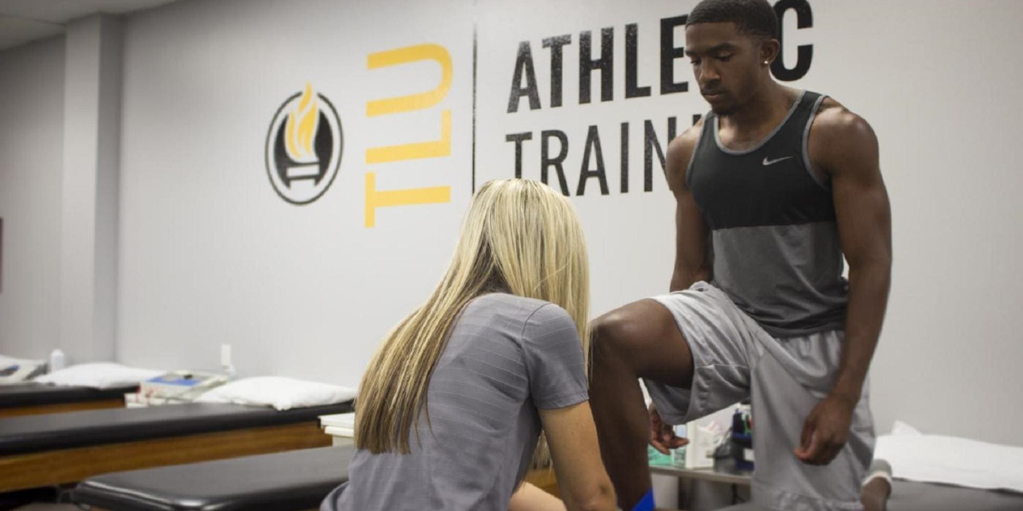 Trainer working on a student's ankle