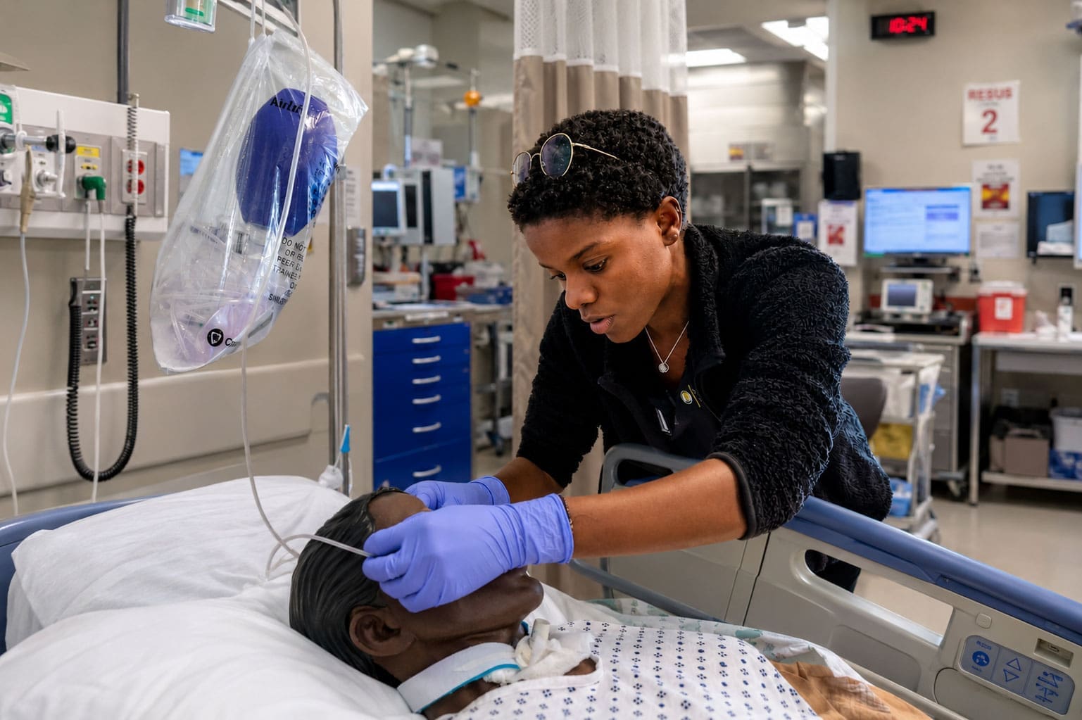 A TLU nursing student attends to a patient