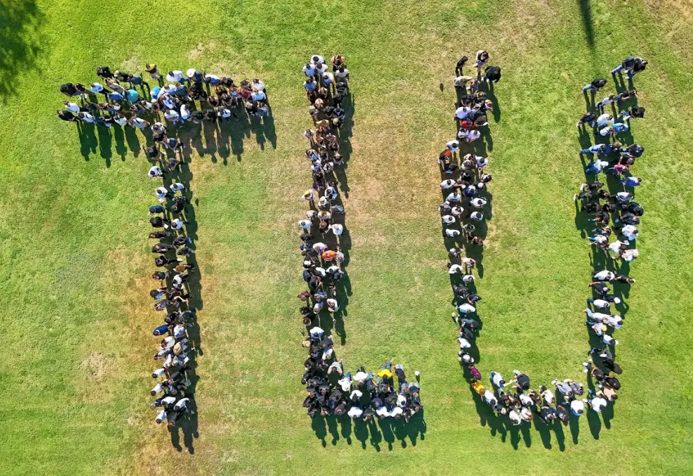 Drone picture of students lined up and forming the letters TLU