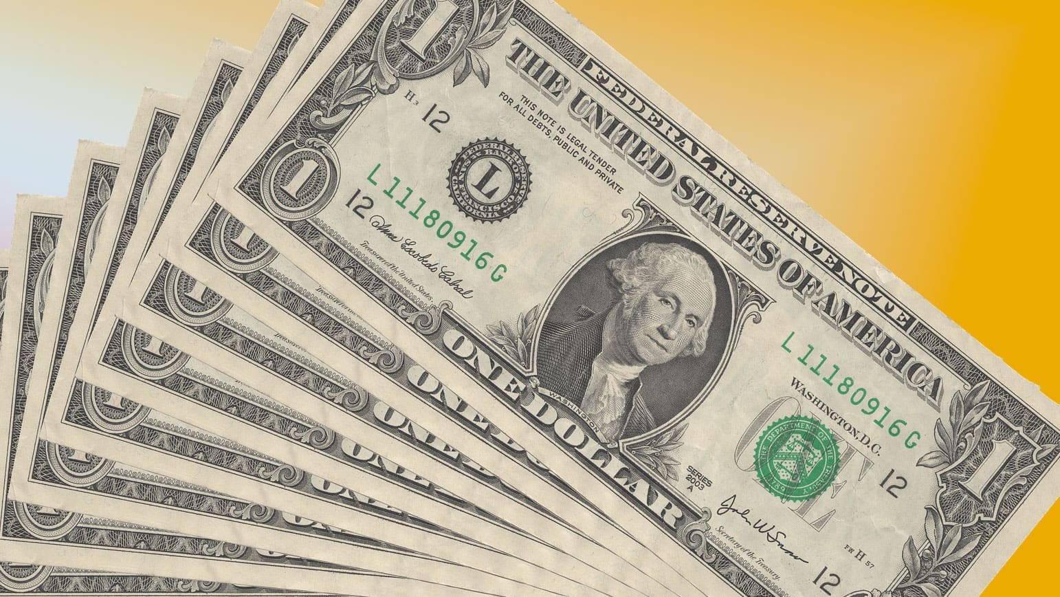 A fan of dollar bills on a gold background