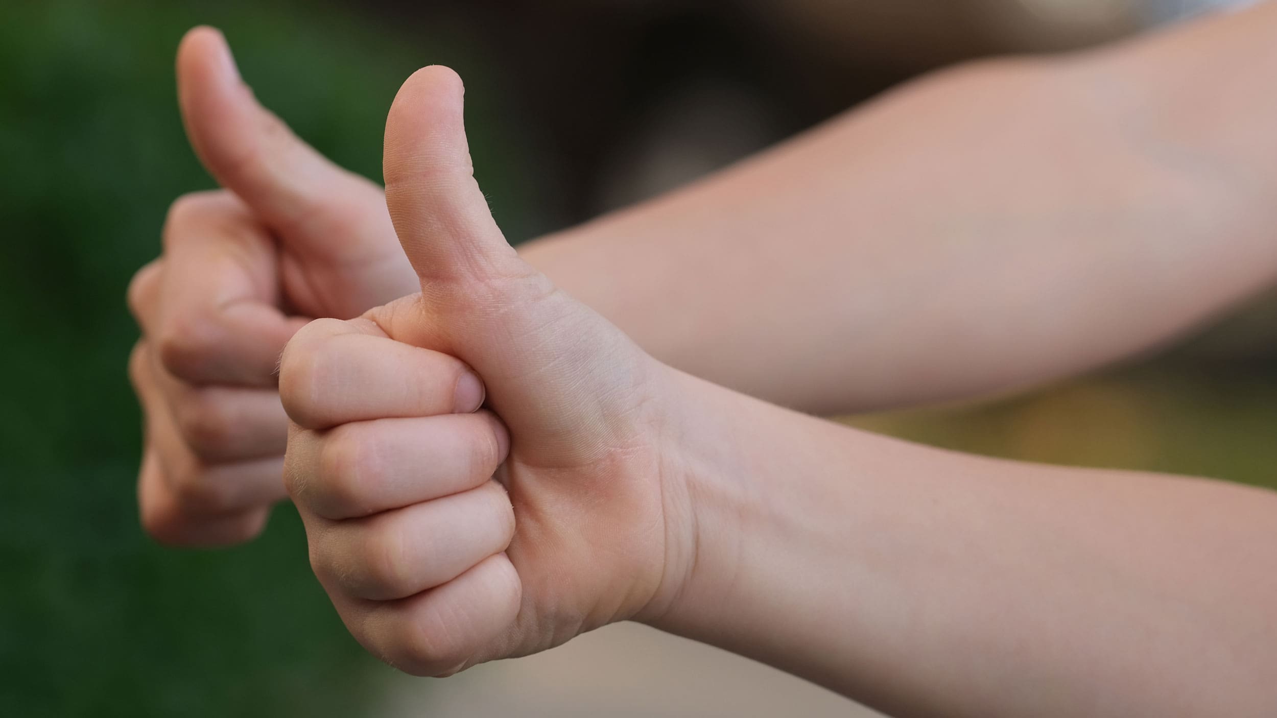 Two hands giving a thumbs up