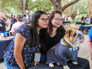 Student and mom posing with Talulah the Bulldog